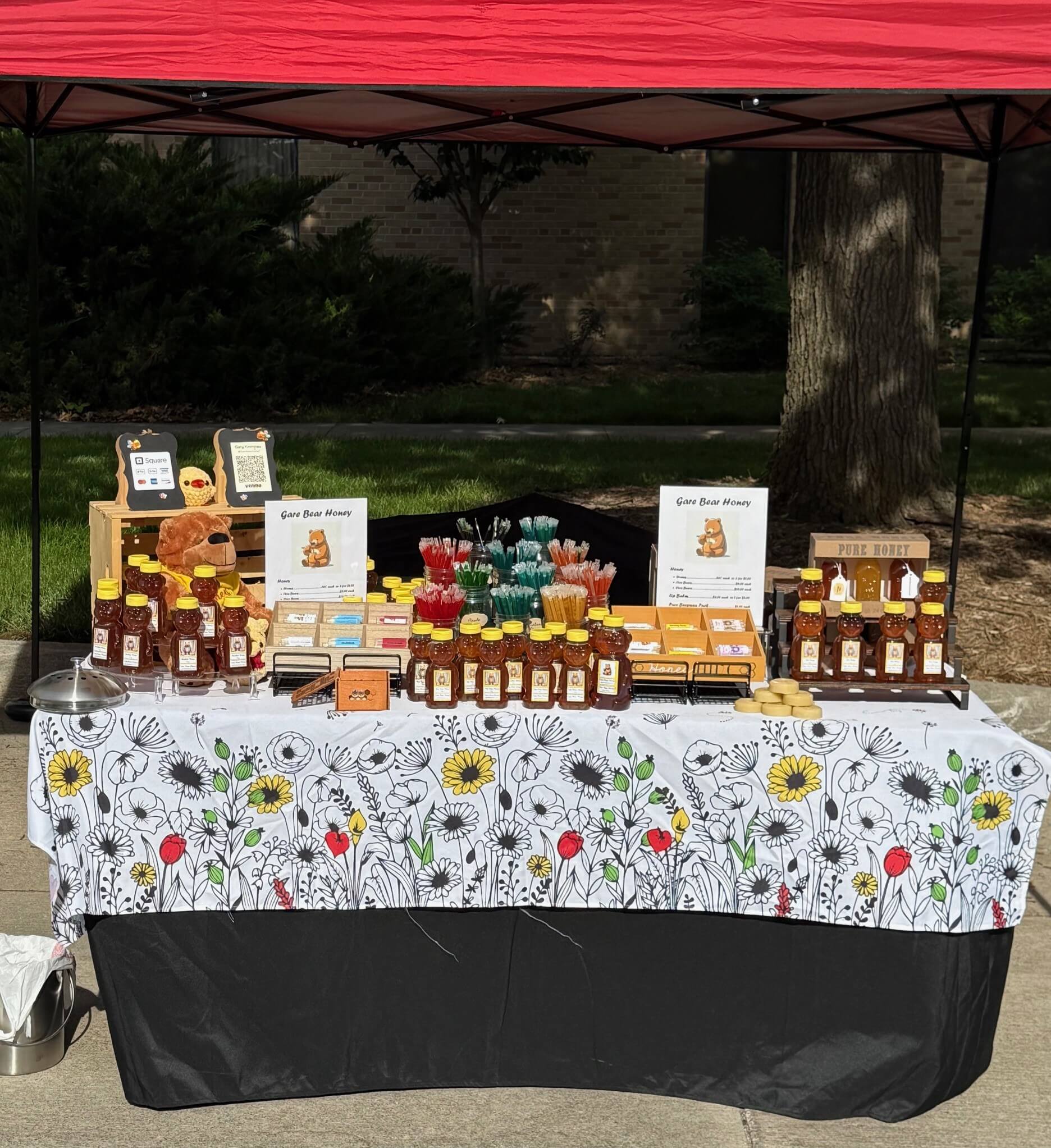 Gare Bear honey farmers market stand with honey and various products